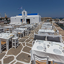white church and restaurant in Naousa town, Paros island, Cyclades