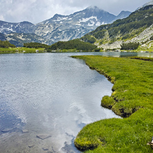 Amazing view of  green meadows around Muratovo lake, Pirin Mountain, Bulgaria