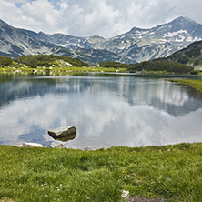 Amazing Landscape of  Banderishki Chukar peak and reflection in Muratovo lake, Pirin Mountain, Bulgaria