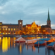 Night photo of Fraumunster Church and reflection in Limmat River, city of Zurich, Switzerland