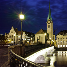 Night photo of Fraumunster Church and bridge over Limmat River, city of Zurich, Switzerland