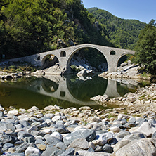 Reflection of Devil"s Bridge and Rhodopes mountain in Arda river, Kardzhali Region, Bulgaria