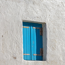 Blue window on medieval white house, island of Mykonos, Cyclades, Greece