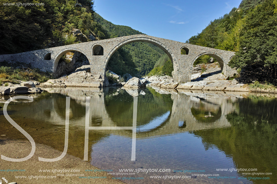 Reflection of The Devil"s Bridge in Arda river and Rhodopes mountain, Kardzhali Region, Bulgaria
