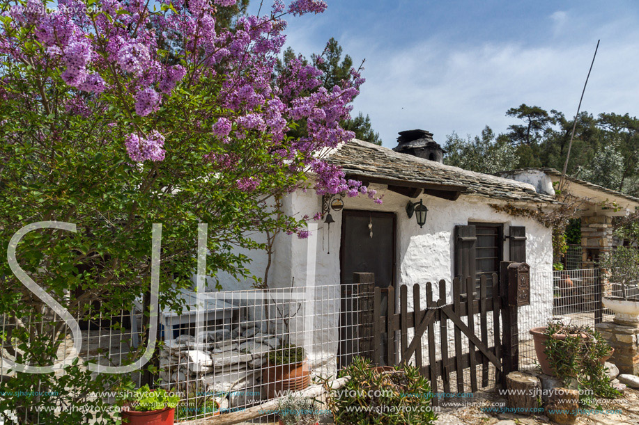 Old stone house and violet flowers in village of Aliki, Thassos island, East Macedonia and Thrace, Greece