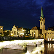 Night photo of Fraumunster Church and bridge over Limmat River, city of Zurich, Switzerland