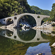 Reflection of Devil Bridge and Rhodopes mountain in Arda river, Kardzhali Region, Bulgaria