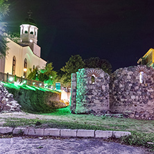Night photo of Saints Cyril and Methodius church and reconstructed gate part of Sozopol ancient fortifications, Bulgaria