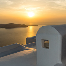 White roof and Amazing sunset in town of Imerovigli, Santorini island, Thira, Cyclades, Greece