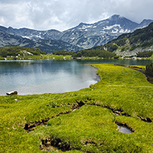 Amazing panorama of Banderishki chukar peak and Reflection in Muratovo lake, Pirin Mountain, Bulgaria