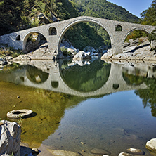 Reflection of Devil"s Bridge in Arda river and Rhodopes mountain, Kardzhali Region, Bulgaria