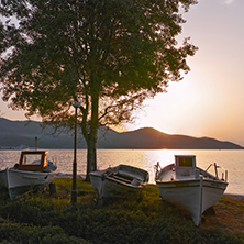 Old boats and Sunset on embankment of Thassos town, East Macedonia and Thrace, Greece