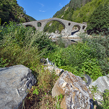 Reflection of Devil"s Bridge in Arda river and Rhodopes mountain, Kardzhali Region, Bulgaria