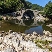 Reflection of Devil"s Bridge and Rhodopes mountain in Arda river, Kardzhali Region, Bulgaria