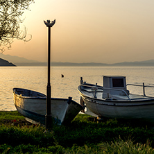 Sunset view on embankment and old boats in Thassos town, East Macedonia and Thrace, Greece