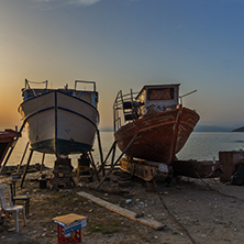 Sunset view of old boats in Thassos town, East Macedonia and Thrace, Greece