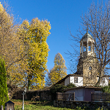 Autumn trees and Church of Saint Prophet Elijah in village of Bozhentsi, Gabrovo region, Bulgaria