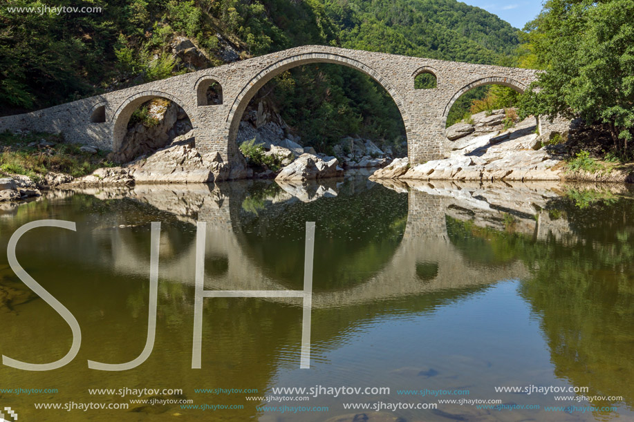 Reflection of Devil"s Bridge and Rhodopes mountain in Arda river, Kardzhali Region, Bulgaria