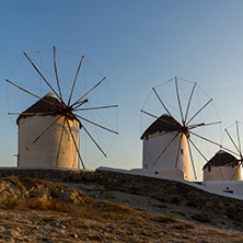 Sunset of White windmills and Aegean sea on the island of Mykonos, Cyclades, Greece