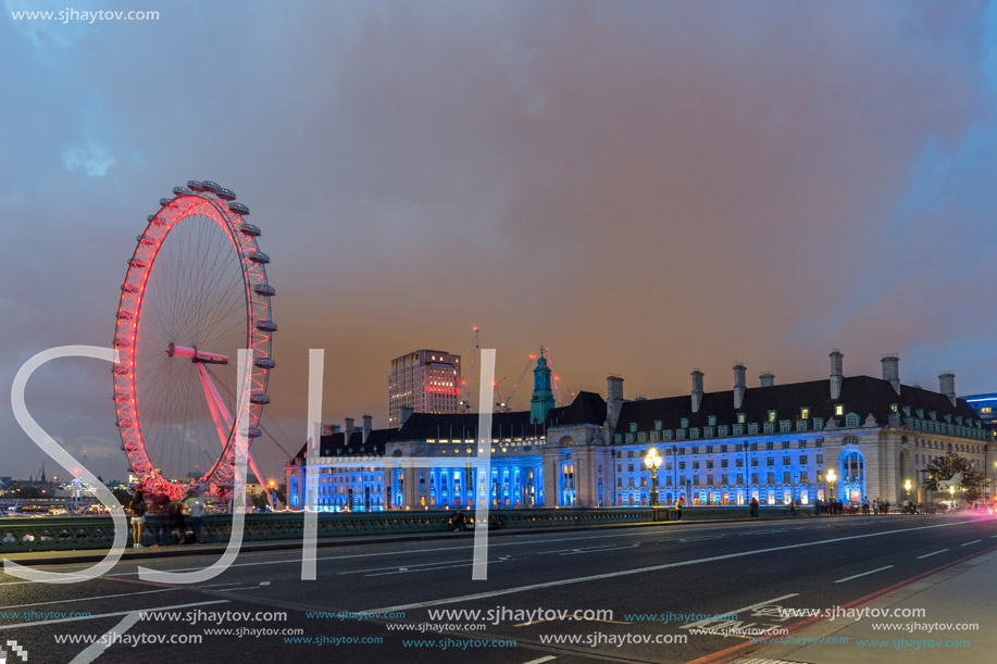 LONDON, ENGLAND - JUNE 16 2016: Night photo of The London Eye and County Hall from Westminster bridge, London, England, Great Britain