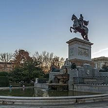 MADRID, SPAIN - JANUARY 22, 2018:  Sunset view of Monument to Felipe IV and the Royal Palace of Madrid, Spain