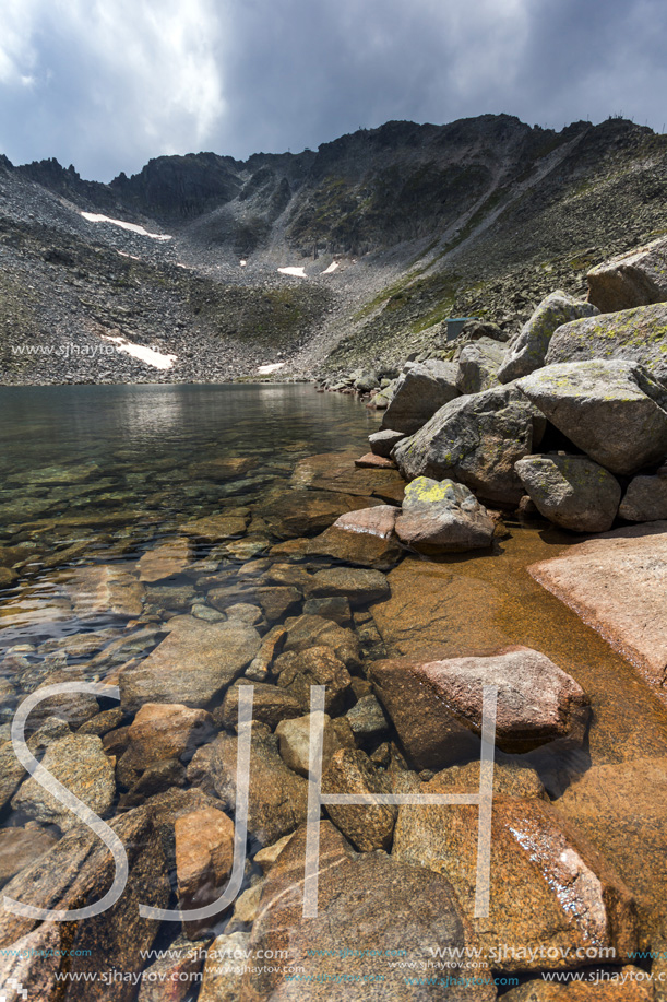 Amazing panorama of Ledenoto (Ice) Lake and clouds over Musala Peak, Rila mountain, Bulgaria