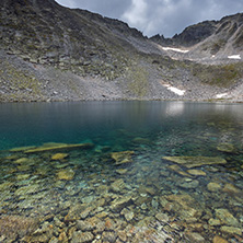 Amazing panoramic view of Ledenoto (Ice) Lake and clouds over Musala Peak, Rila mountain, Bulgaria