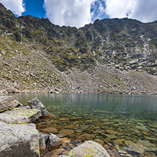 Amazing panoramic view of Ledenoto (Ice) Lake and clouds over Musala Peak, Rila mountain, Bulgaria