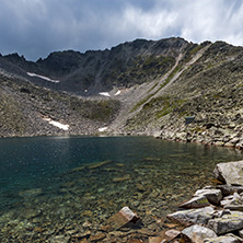 Amazing panoramic view of Ledenoto (Ice) Lake and clouds over Musala Peak, Rila mountain, Bulgaria