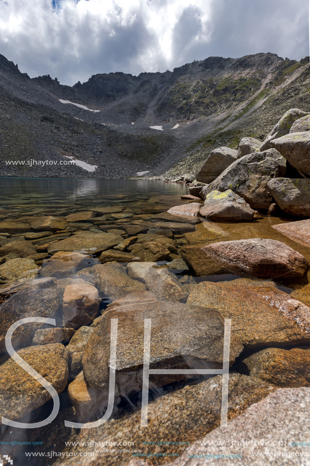 Amazing panoramic view of Ledenoto (Ice) Lake and clouds over Musala Peak, Rila mountain, Bulgaria