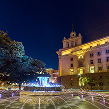 SOFIA, BULGARIA - JULY 21, 2017: Night photo of Fountain in front of The Building of the Presidency and Former Communist Party House in Sofia, Bulgaria