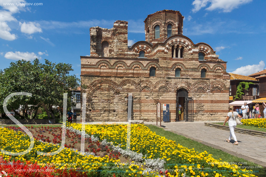 NESSEBAR, BULGARIA - AUGUST 12, 2018: Flower garden in front of Ancient Church of Christ Pantocrator in the town of Nessebar, Burgas Region, Bulgaria